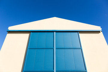 white hangar with blue gate