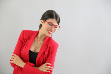 Beautiful brunette girl with red jacket and eyeglasses, isolated