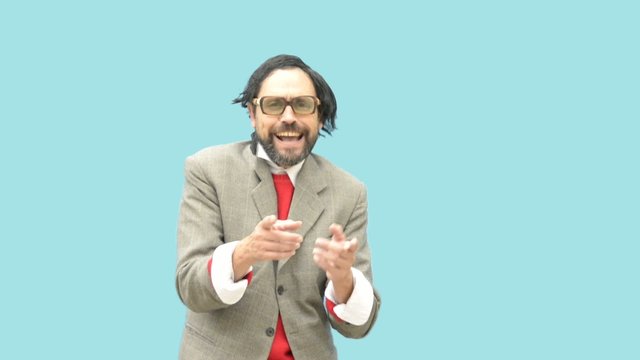 An untidy man, wearing glasses, laughing out loud