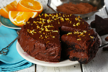 Chocolate cake with oranges on table, close-up