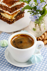 Cup of coffee and tiramisu cake