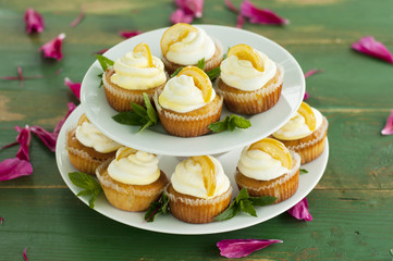 Cupcakes with decoration on green wooden table