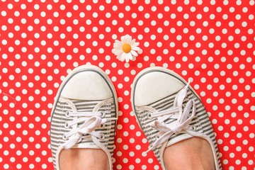 Pumps and a daisy on red polka dots