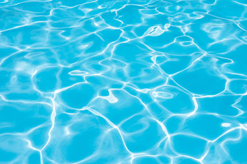 Fototapeta na wymiar Blue and bright water surface in swimming pool