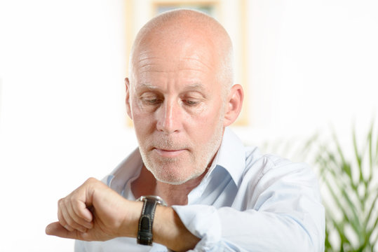 A Man  Looks At His Watch