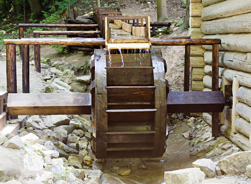 Wooden wheel of an ancient water mill in open-air museum