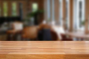 Empty wooden table and blurred cafe background