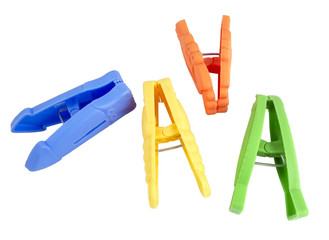 colored clothes-pegs on white background