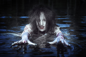 Fototapeta na wymiar Beautiful witch woman standing in the river
