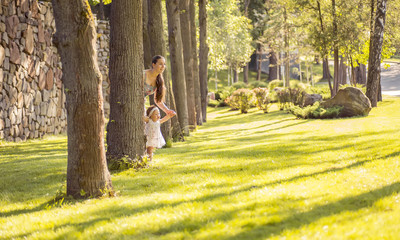 Fototapeta premium mother and daughter walking in the park, happy summer