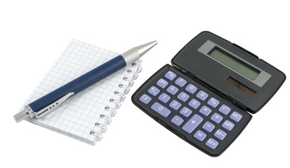Calculator, pen laying on blank notebook