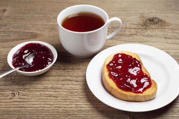 White bread with jam and tea cup