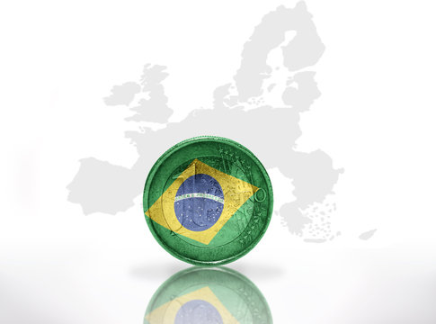 euro coin with brazilian flag on the european union map background