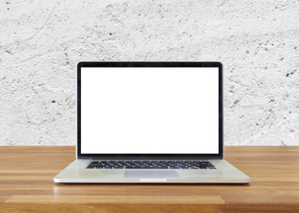 Laptop on table, on  white cement wall background