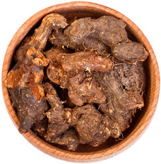 Galangal root in a small wooden bow isolated on white.