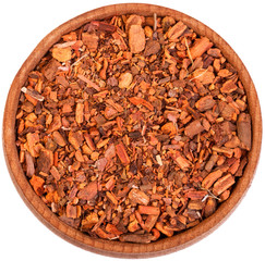 Root of Rubia Tinctorum in a small wooden bow isolated on white.