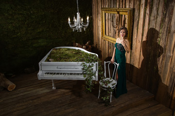 Beautiful woman near the piano
