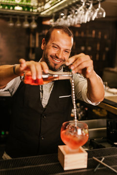 Barman Preparing a Strawberry Cocktail