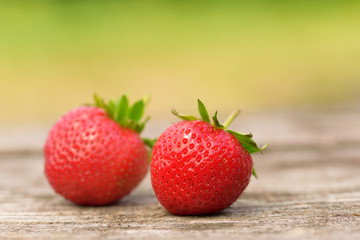 Ripe strawberries on wooden background