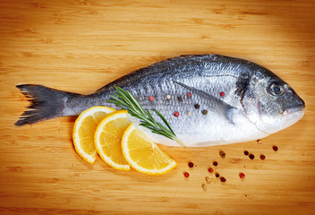 Fresh fish dorado on wooden background