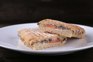 Fresh and tasty sandwiches on plate on wooden background