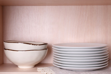 Tableware on wooden shelf