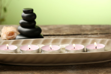 Beautiful spa composition on wooden table, on green background