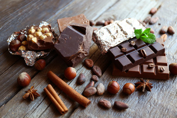 Delicious chocolate with spices on wooden table, closeup
