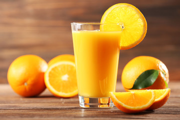 Orange juice on table on wooden background