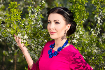 young beautiful woman in cherry-tree garden