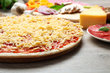 Raw pizza on table close up