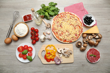 Food ingredients for pizza on table close up