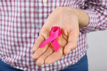 Female hand with color ribbon, closeup