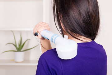 Woman massaging the body with infrared lamps massager