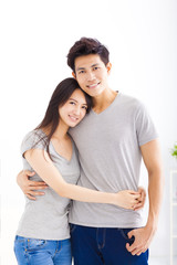 Fototapeta premium Young happy couple hugging and smiling
