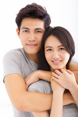 Young happy couple hugging and smiling