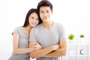 Obraz premium Young happy couple hugging and smiling