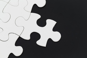 Plain white jigsaw puzzle on Black background