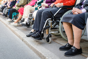 Row of old people in wheel chairs.  - obrazy, fototapety, plakaty