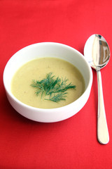 served lentil soup puree on red table
