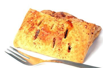 isolated dessert roll and fork on white
