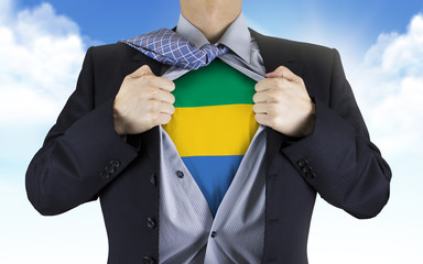 businessman showing Gabon flag underneath his shirt