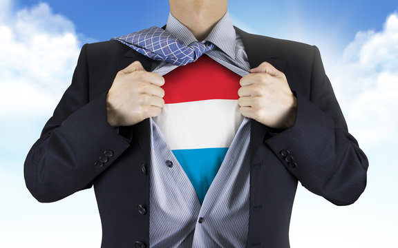 businessman showing Luxembourg flag underneath his shirt