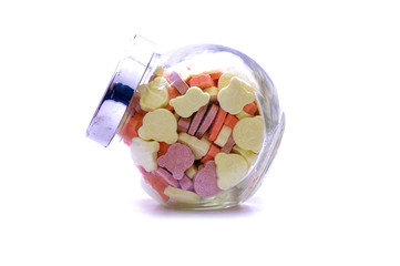 Tablet Vitamins In A Glass Jar Over White Background