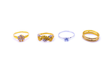 Collection of gold and silver rings over white background