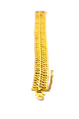 Gold bracelet over white background