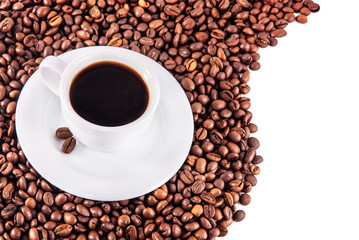 Cup of coffee with saucer and beans on white background