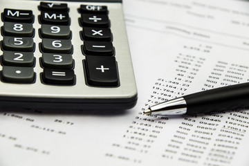 Bank statement with calculator and pen
