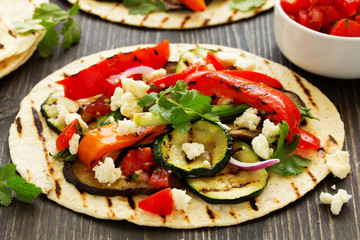 Vegetarian snack tacos with grilled vegetables and salsa.