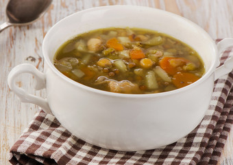 White Bowl of Soup with Lentils, Beans, Chicken and Vegetables.